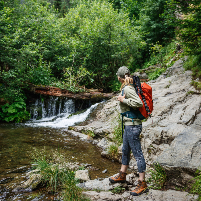 Woman hiking down river